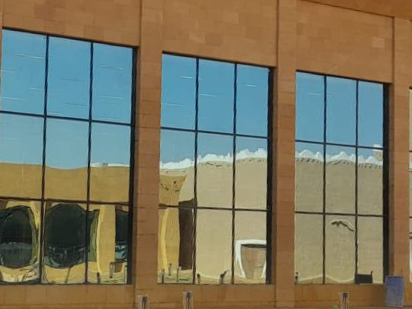 Large aluminum-framed windows on a commercial building in Riyadh